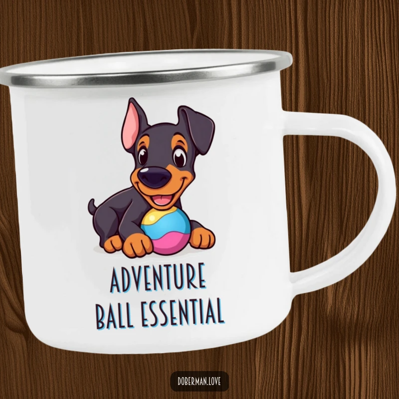Funny Doberman Camping Mug: Cheerful dog nudging a colorful toy, a humorous and durable outdoor mug.