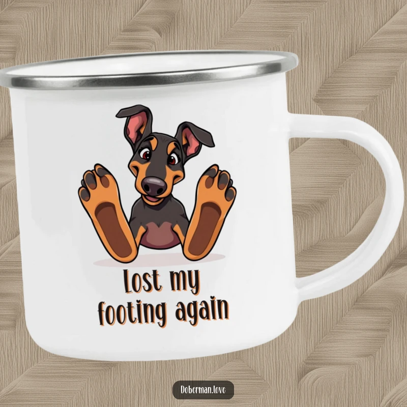 Funny Doberman dog tripping over paws on a sturdy camping mug, ideal for outdoor enjoyment and laughs.