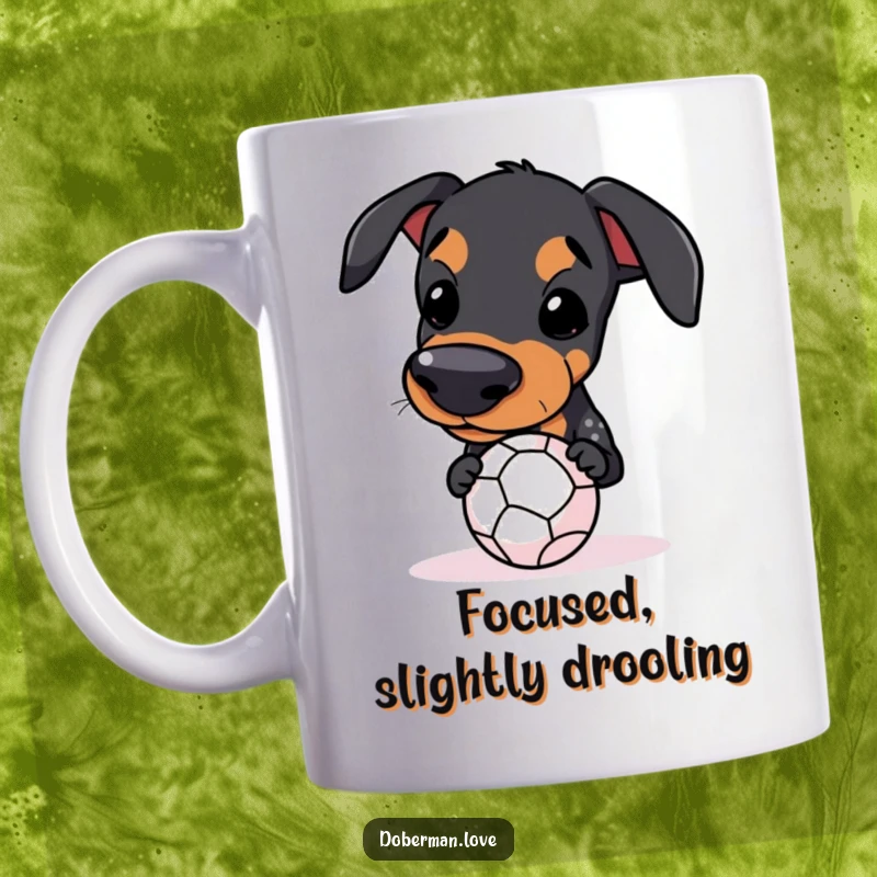 Funny Kawaii Doberman Mug balancing a small ball on its snout, a humorous design for dog lovers.