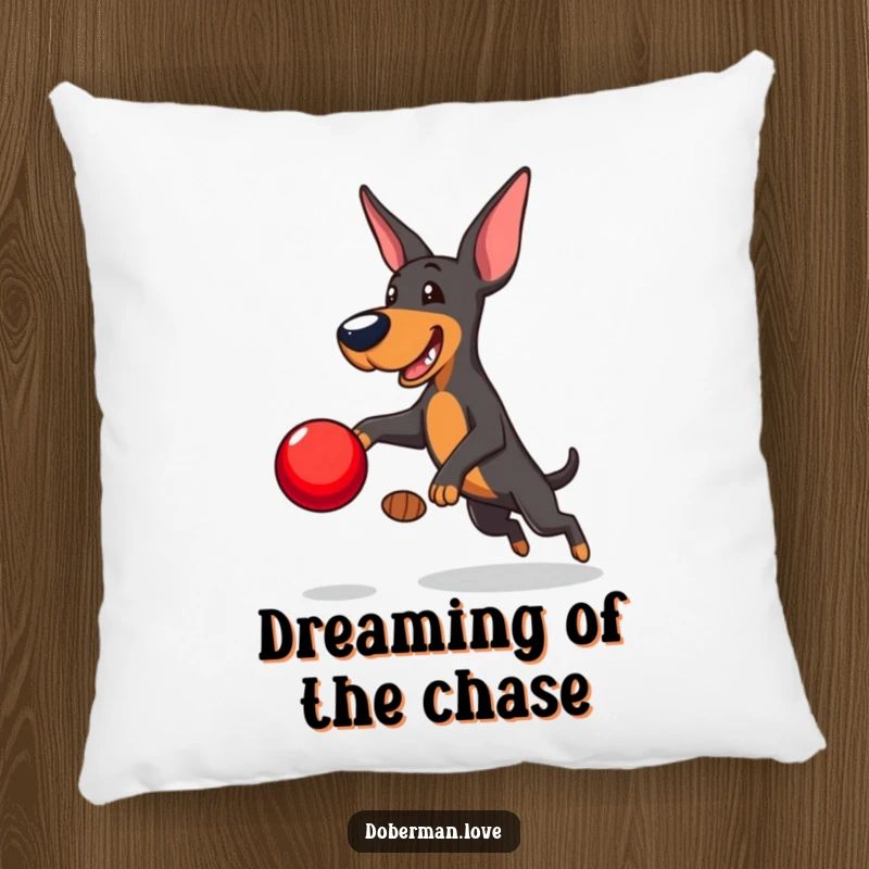 Funny Doberman Pillow: Playful Doberman leaping to catch a red ball, soft and humorous accent pillow for dog enthusiasts.