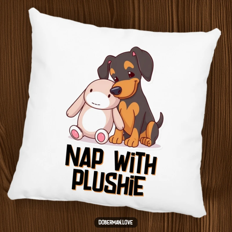 Funny Doberman nudging a big stuffed toy on a soft pillow, adding humorous charm to any cozy space.