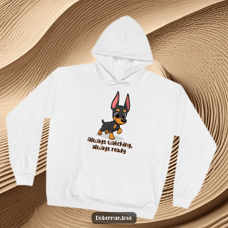 Funny Doberman hoodie featuring a vigilant dog in mid-chase, eyes locked onto a shadowy enigma, a humorous statement of playful alertness.
