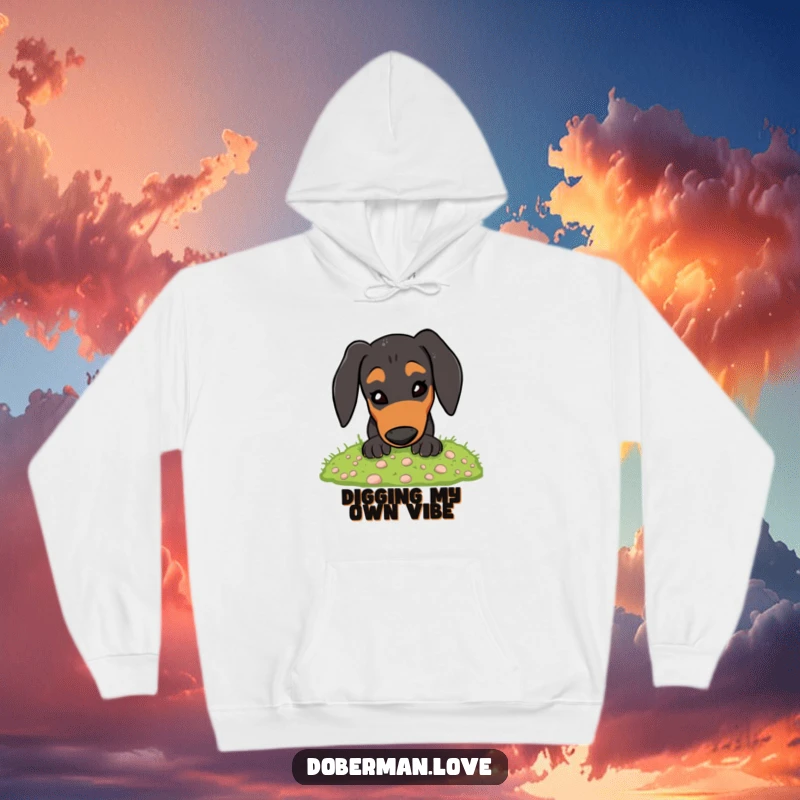 Funny Doberman Hoodie: An energetic dog cheerfully digging in a pile of soft moss, great for humor lovers.
