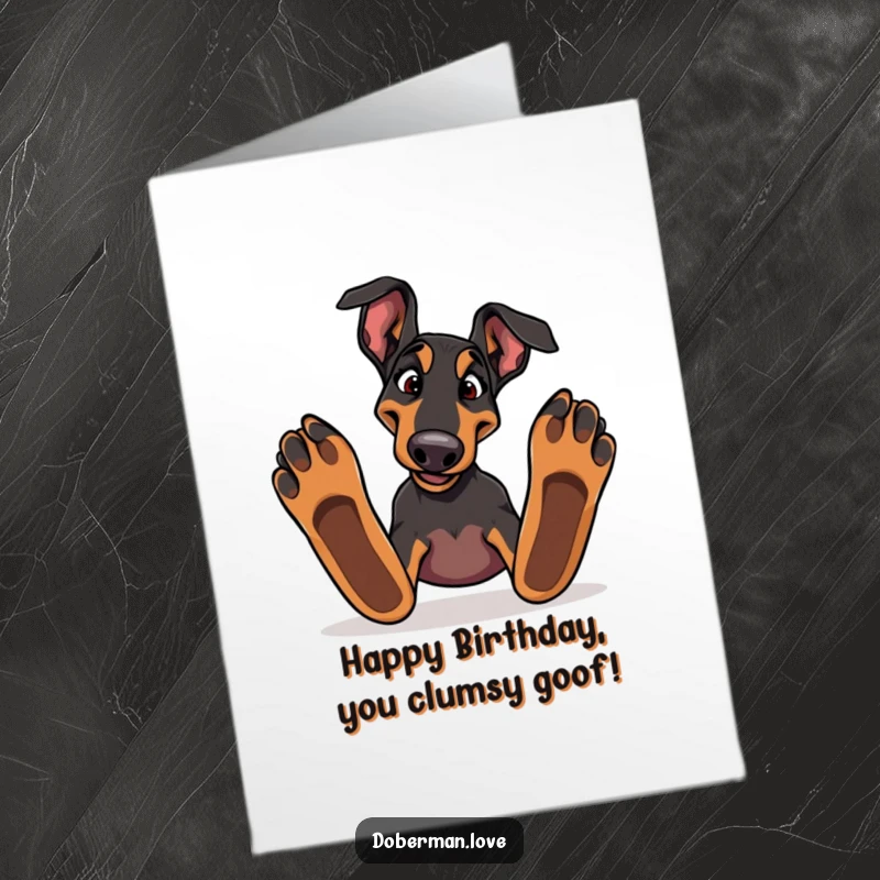 Funny Free Printable Birthday Card: Silly Doberman tripping over its large paws, with a comically surprised expression.