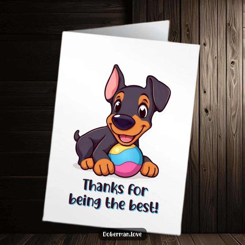 Funny Free Printable Thank You Card featuring a cheerful Doberman nudging a round, colorful toy.