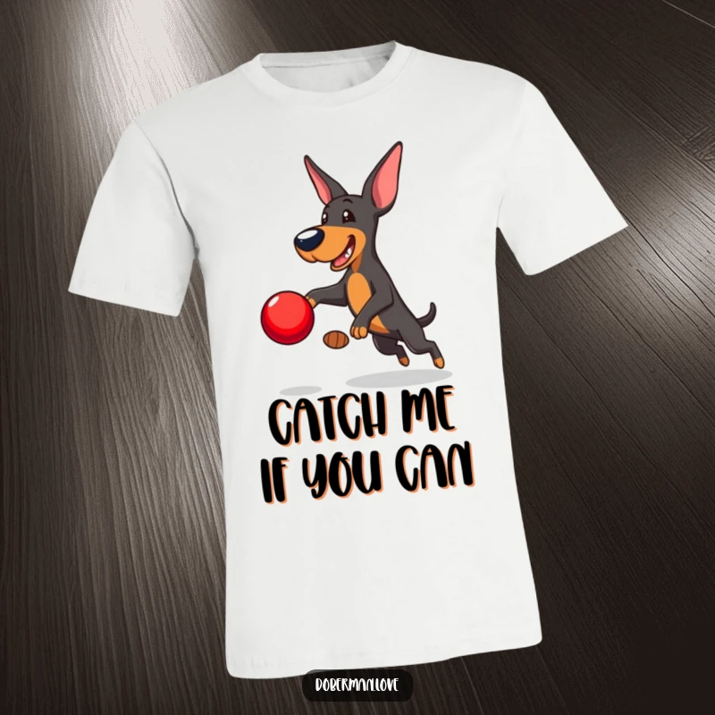Funny Doberman T-Shirt: Playful Doberman leaping to catch a red ball, dynamic and humorous athletic dog graphic.