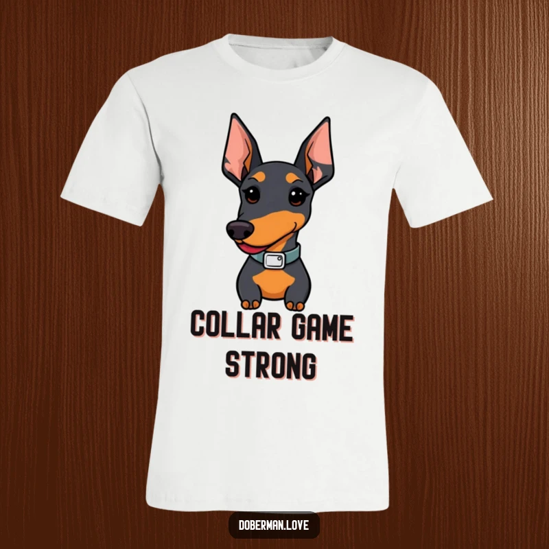 Funny Doberman t-shirt; a Kawaii pup proudly sports a small, chic collar, looking incredibly pleased with itself.