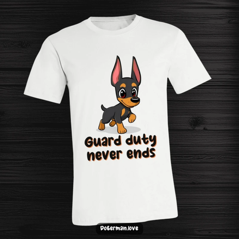 Funny Doberman t-shirt showing a focused dog intently pursuing a mysterious shadow with its watchful eyes, a humorous depiction of doggy antics.