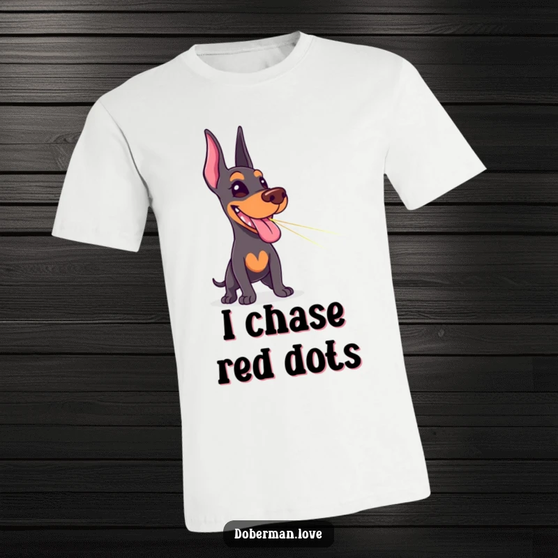Funny Doberman t-shirt depicting a happy dog with its tongue sticking out, hilariously chasing a red laser pointer dot.