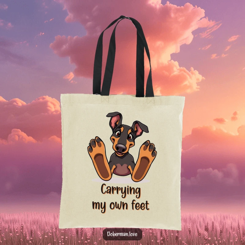 Funny Doberman dog stumbling over large paws on a durable tote bag, ideal for carrying items with humor.