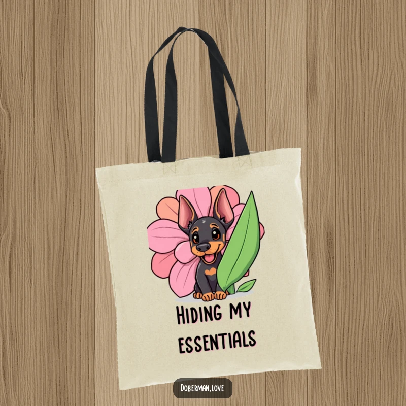 Funny Doberman cub hiding behind a large, colorful flower, captured mid-peek with a happy, curious expression.