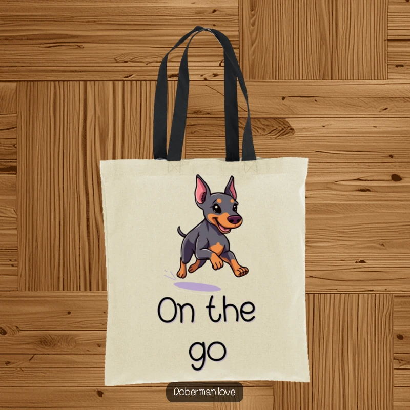 Funny little Doberman tote bag featuring a dog with a sleek coat running with speed, perfect for carrying items with humor.